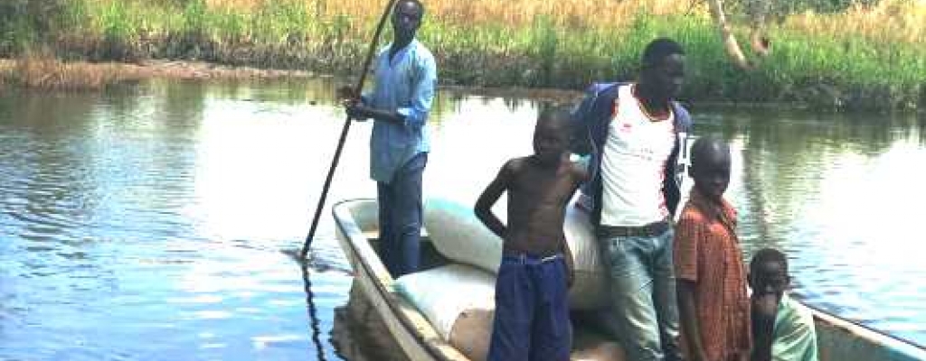 Some people using a boat to link up to Achinga Sub County in Kapelebyong district during rainy season