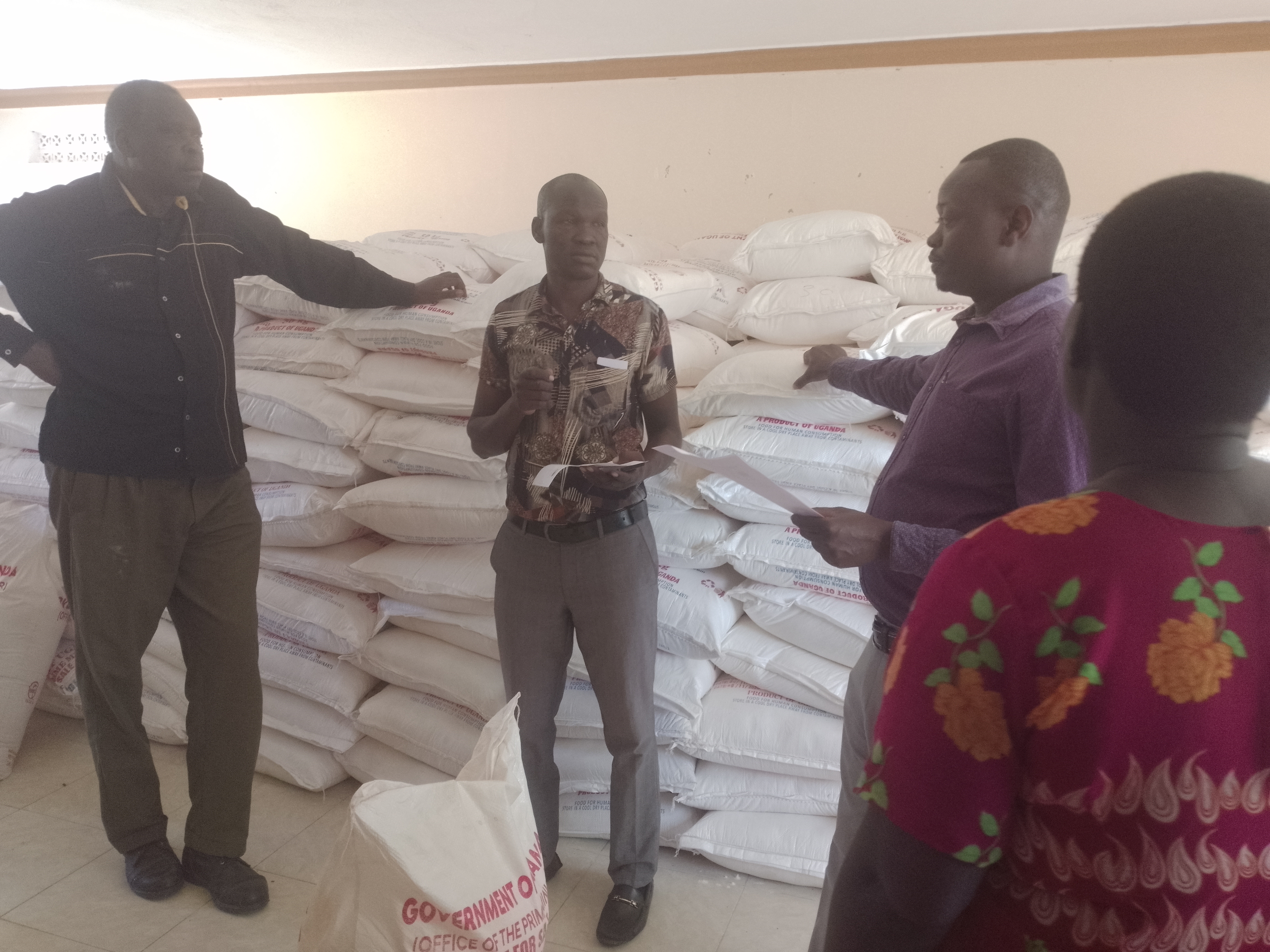 Emmy Ojirot, the deputy RDC of Kapelebyong (third right) officiating the distribution of relief to subcounty authorities at Kapelebyong TC hall on Friday last. Photo by Emmanuel Opio.