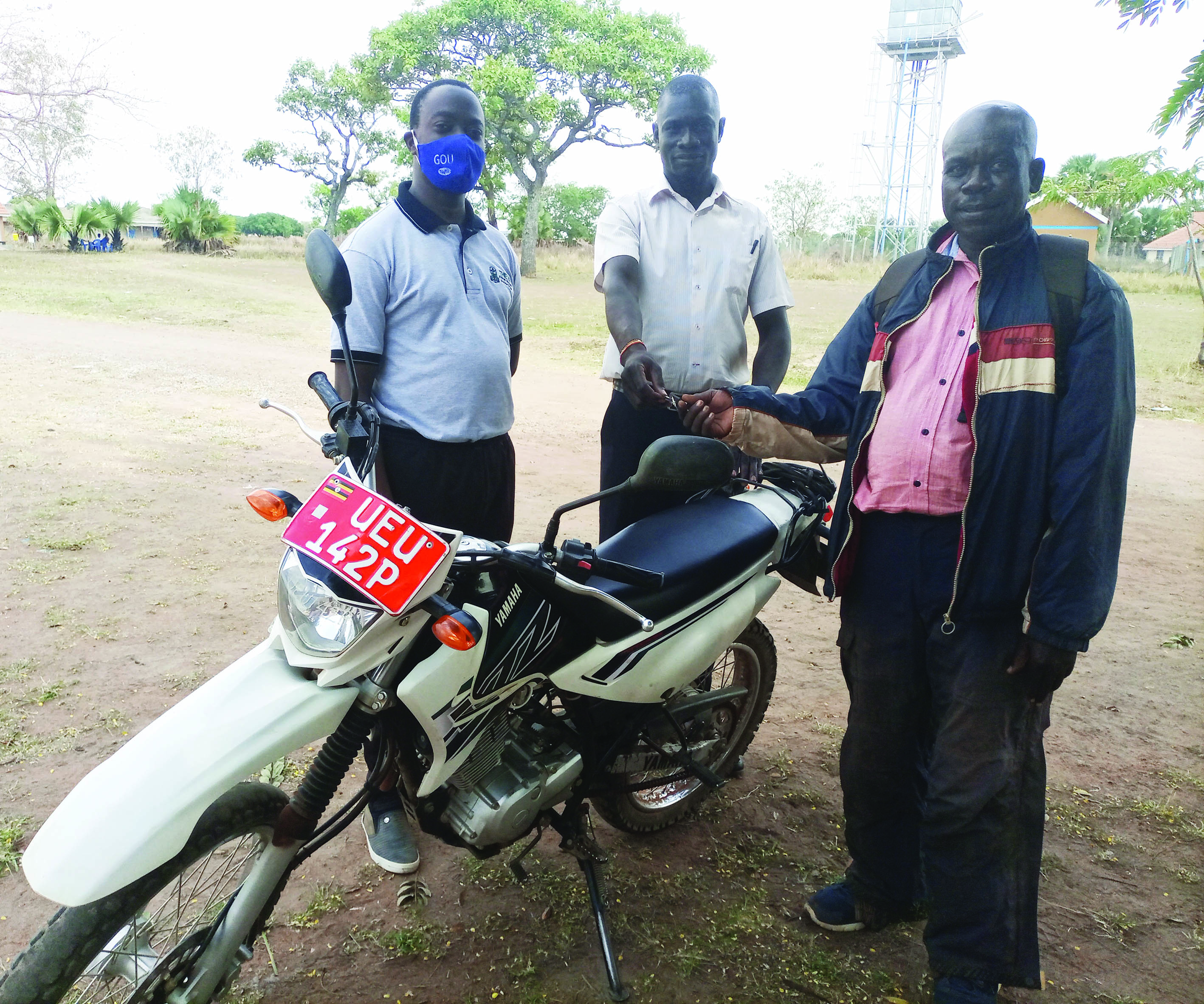Peter Eceru, crop Husbandry Officer and William Ejiet, the Production Officer Kapelebyong during the motorcycle handover