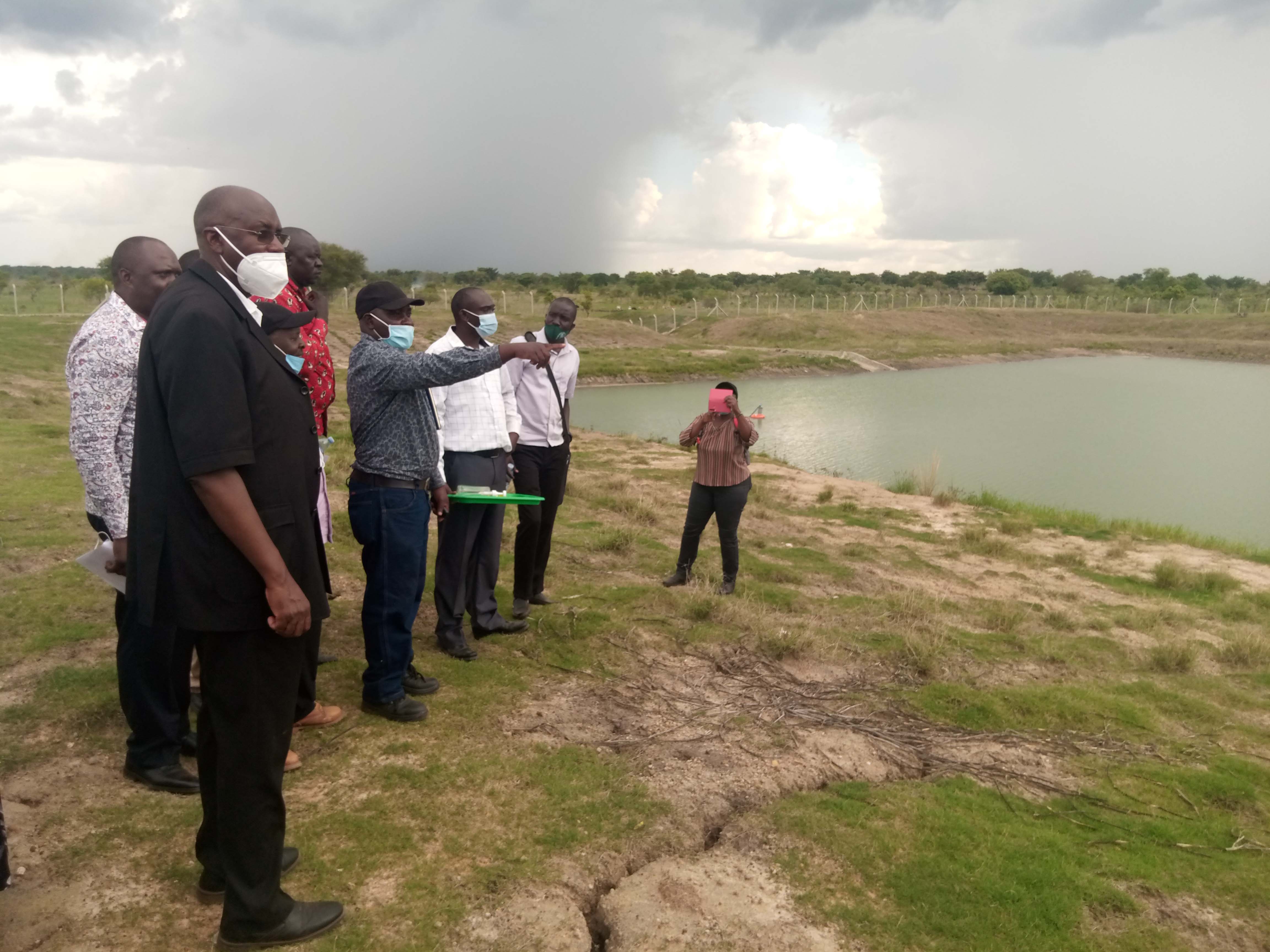 State Minister for Animal Industry and other leaders looking at the valley dam